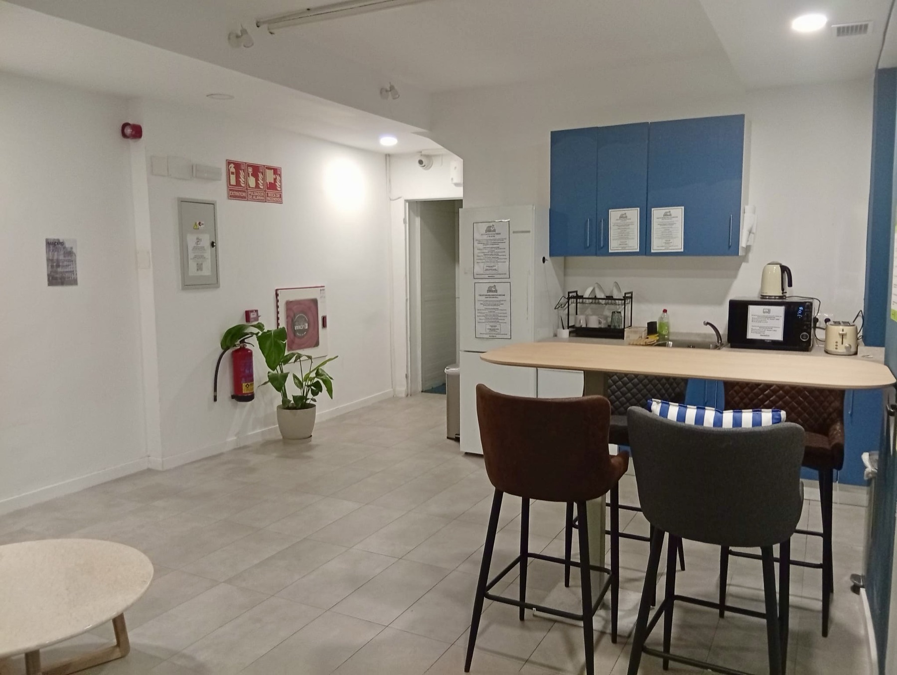 The hostel's bar and shared kitchen with stools